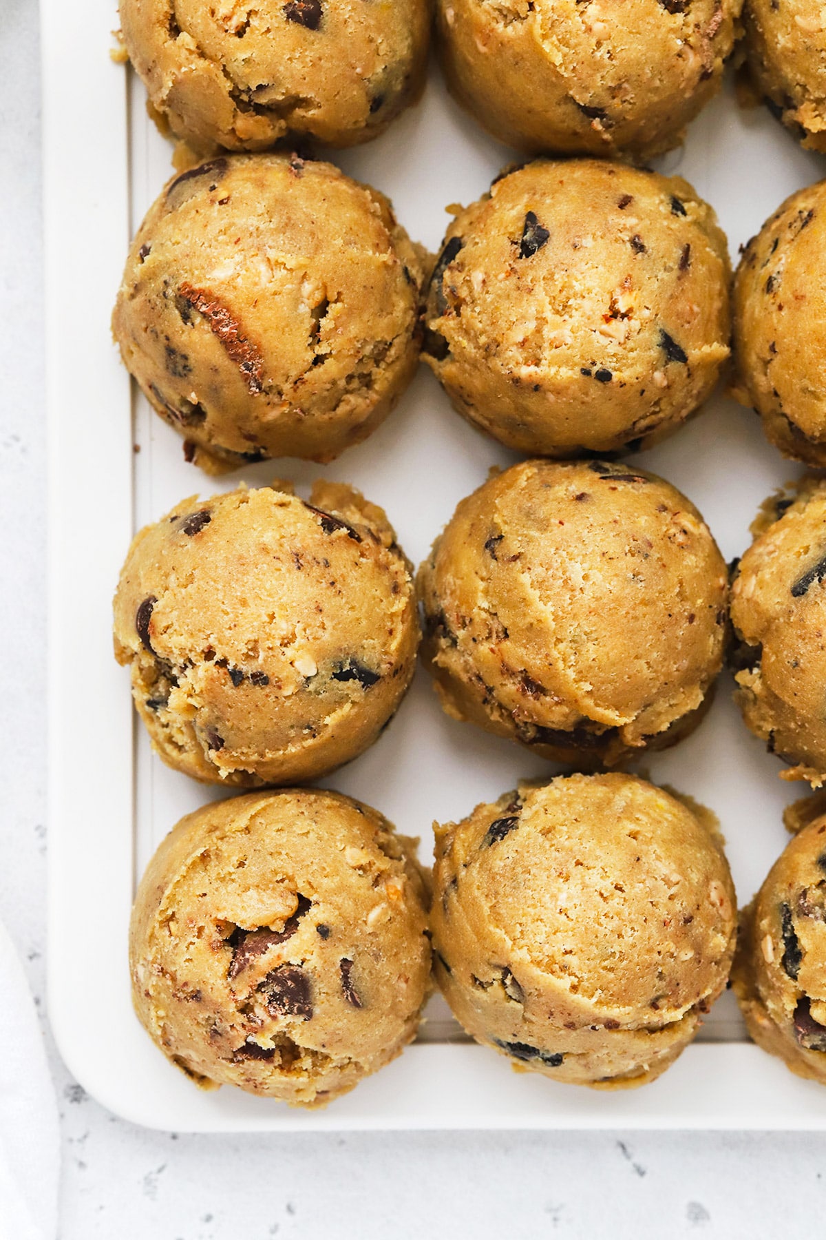 Overhead view of gluten-free brown butter chocolate chip cookie dough scooped into balls arranged neatly in rows