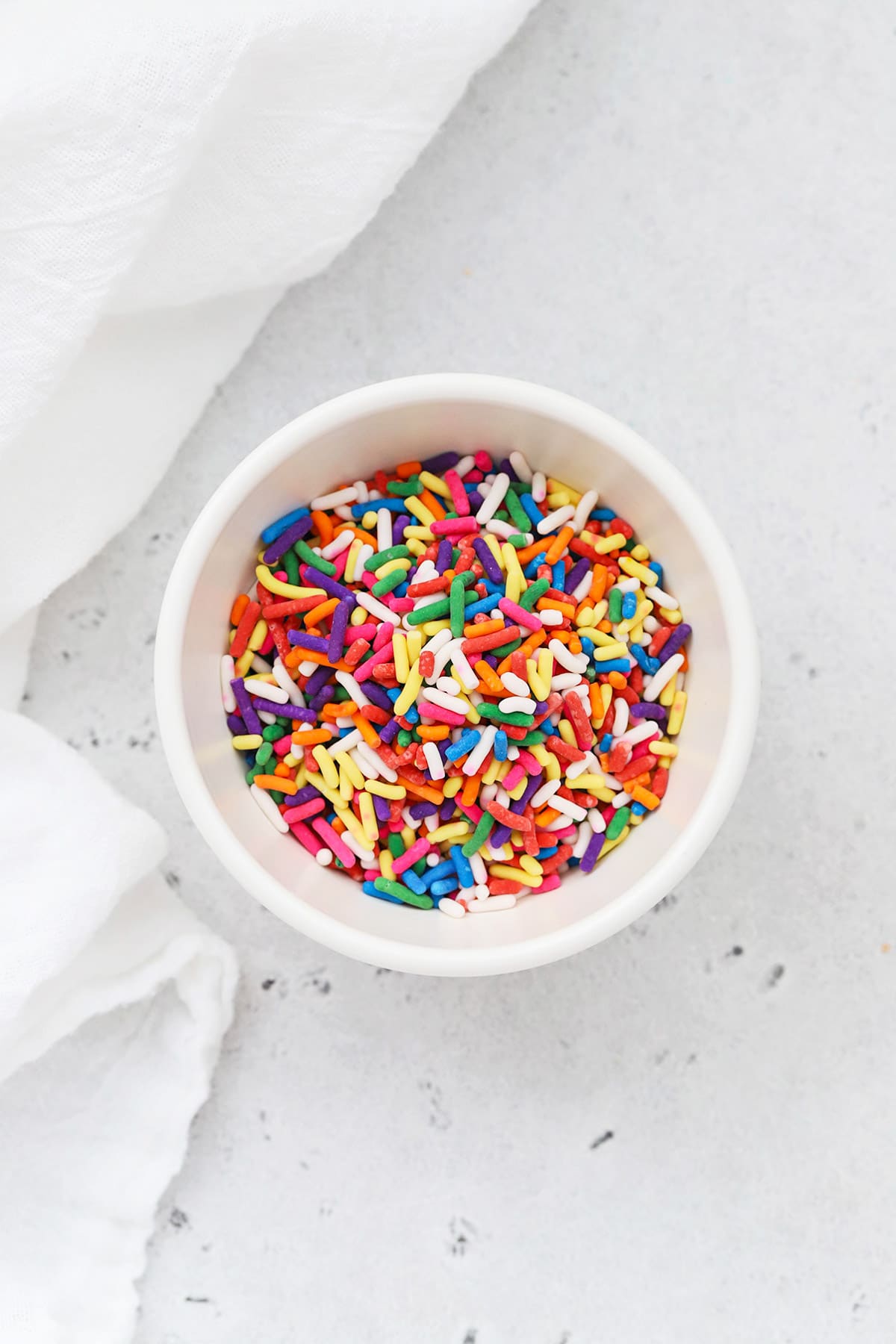 Colorful jimmies sprinkles sprinkles in a white bowl