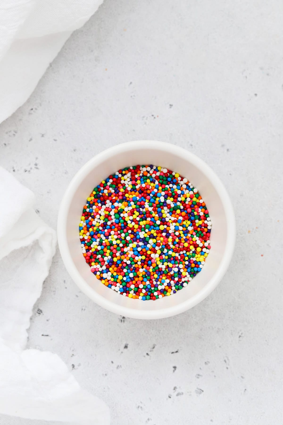 Colorful nonpareils sprinkles sprinkles in a white bowl
