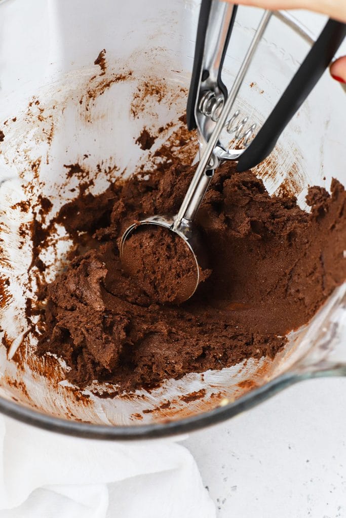 Thick, sticky gluten-free Crumbl chocolate cake cookie dough in a mixer