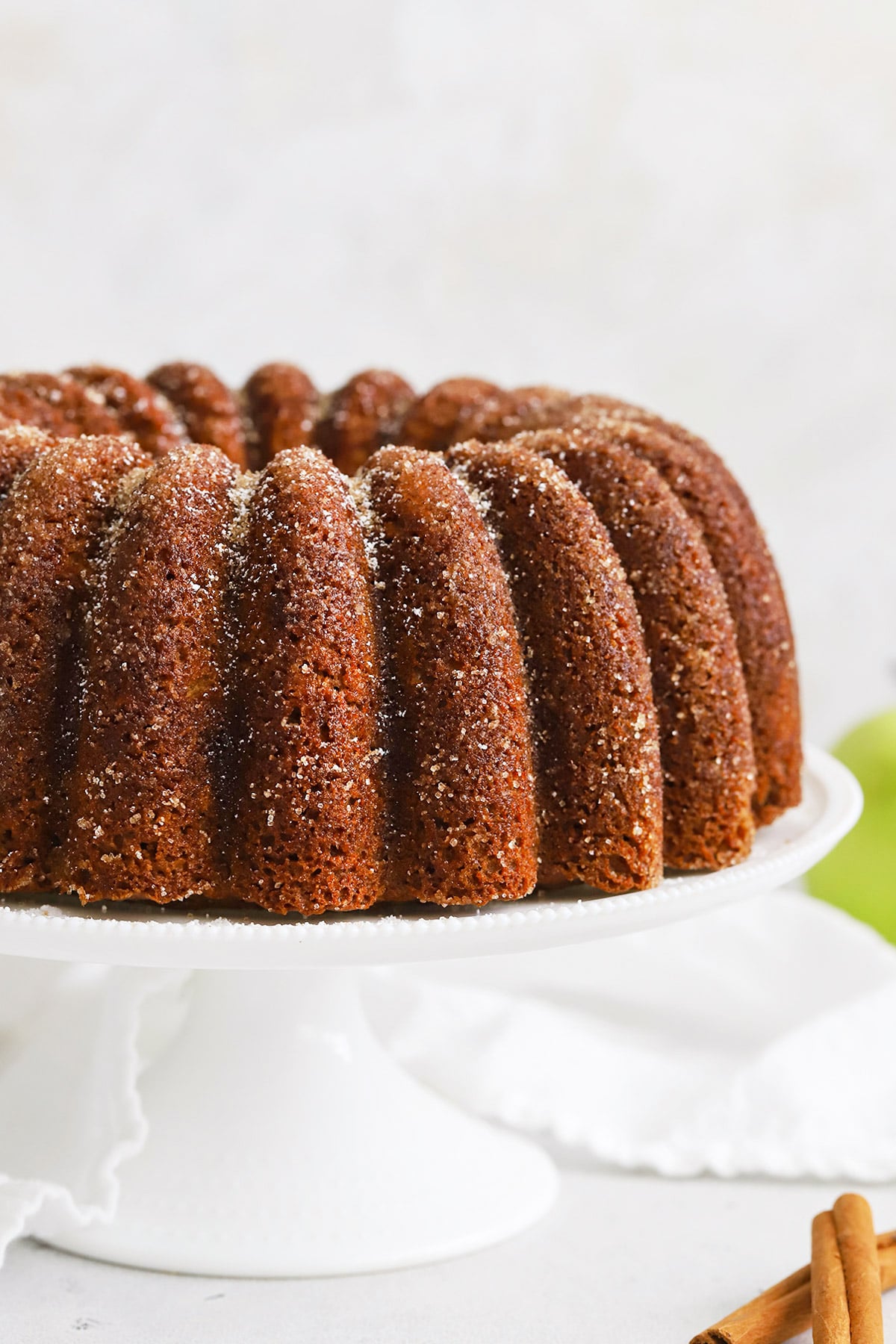 Close up view of gluten-free apple spice bundt cake with cinnamon sugar