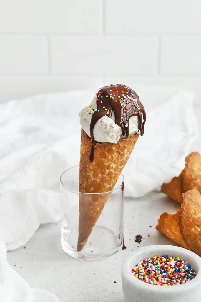 Vanilla ice cream cone topped with magic chocolate shell and sprinkles
