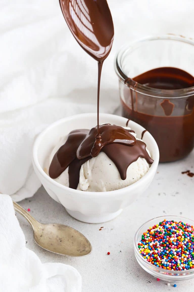 Pouring homemade magic chocolate shell onto vanilla ice cream