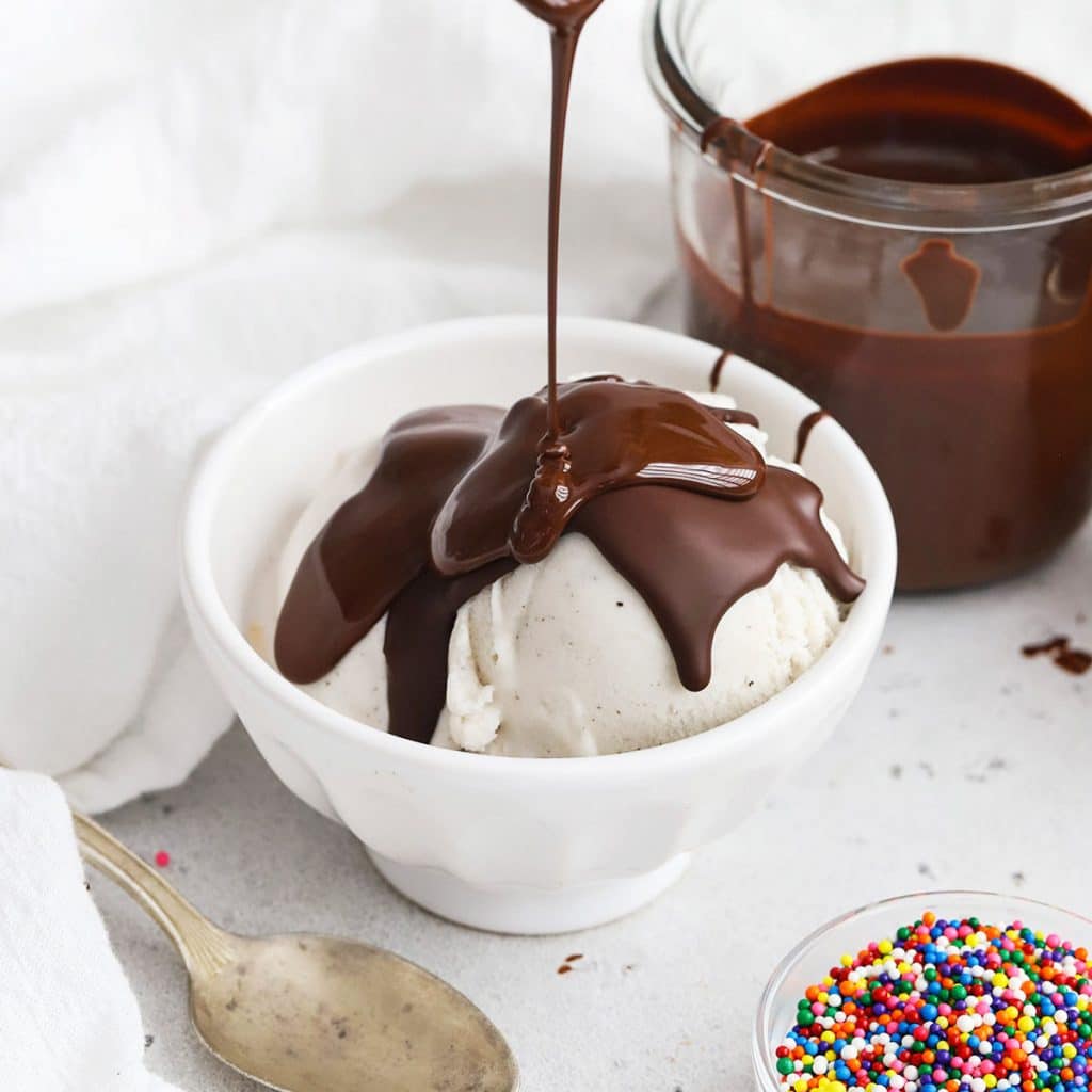 chocolate shell being poured over vanilla ice cream