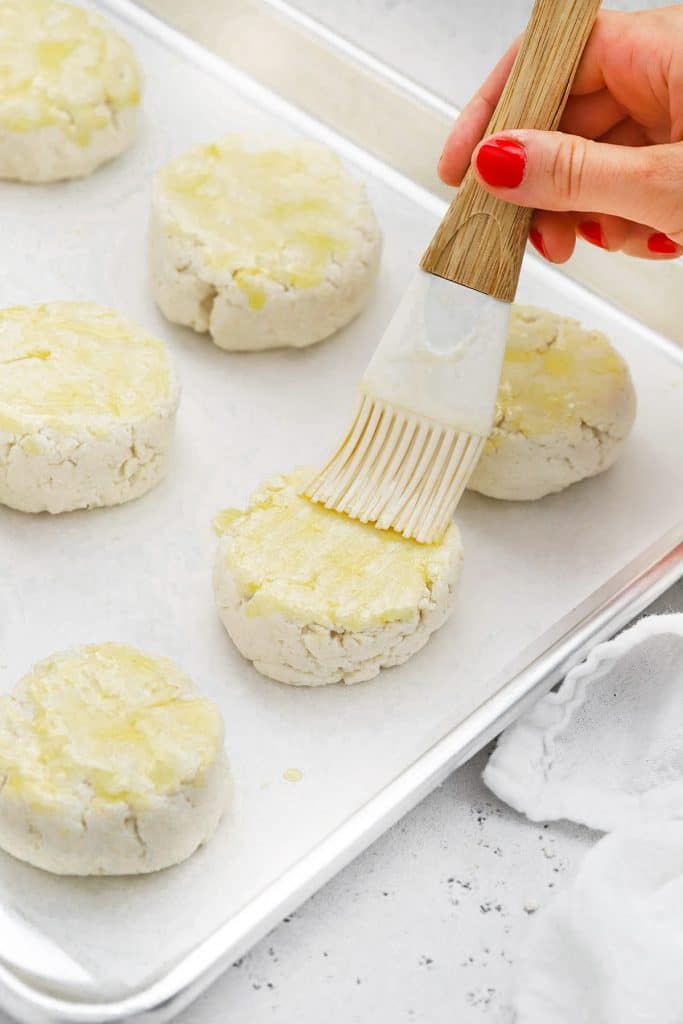 Brushing gluten-free biscuits with melted butter