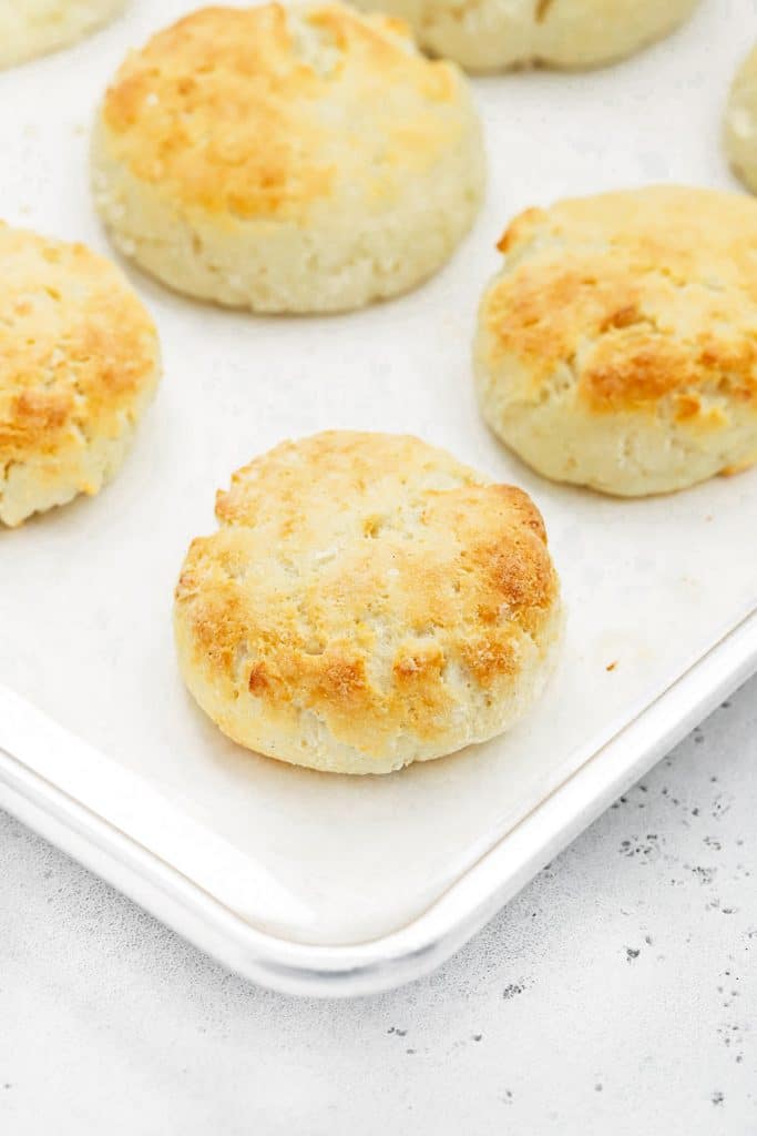 Freshly baked gluten-free biscuits on a baking sheet