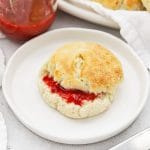 Front view of gluten-free biscuits spread with raspberry freezer jam on the side