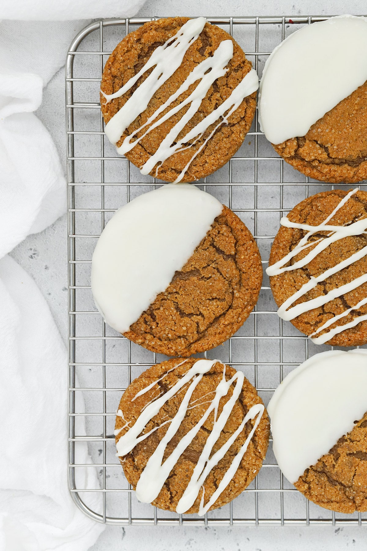 Overhead view of soft, chewy gluten-free ginger cookies drizzled and dipped in white chocolate