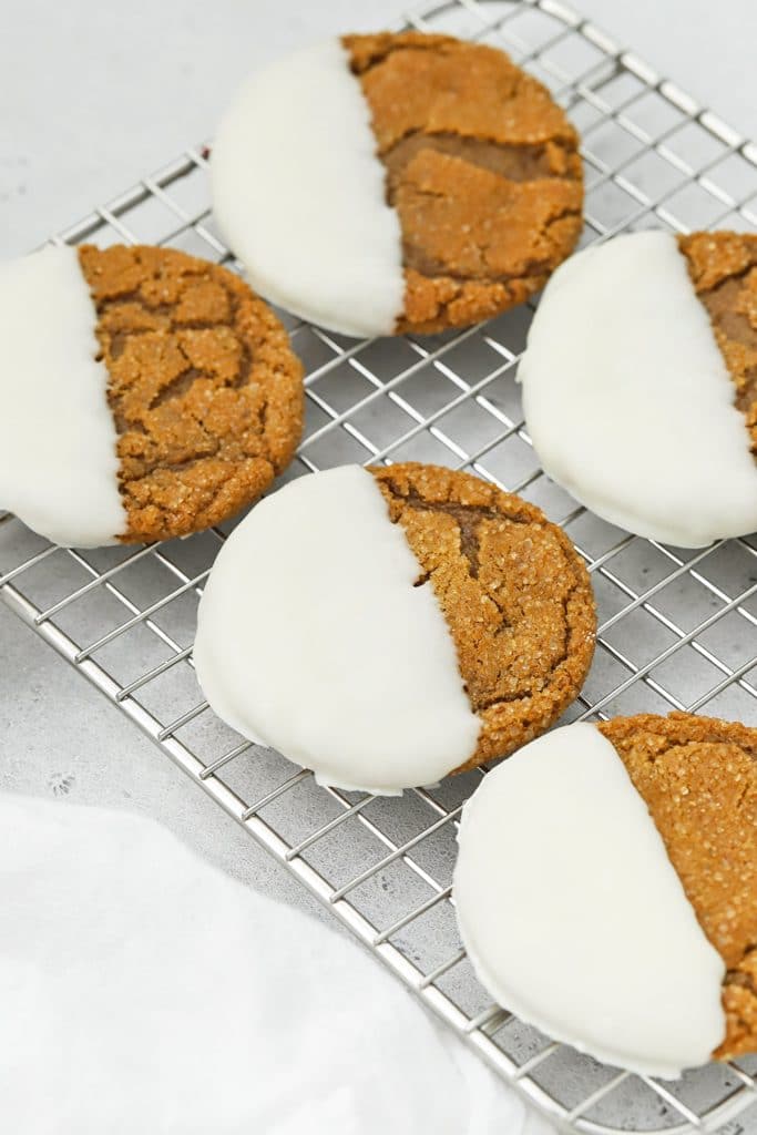 Front view of soft gluten-free ginger cookies dipped in white chocolate
