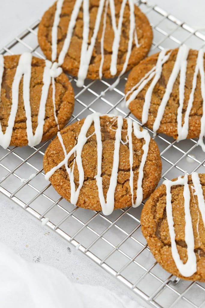 Front view of chewy, soft gluten-free ginger cookies drizzled with white chocolate