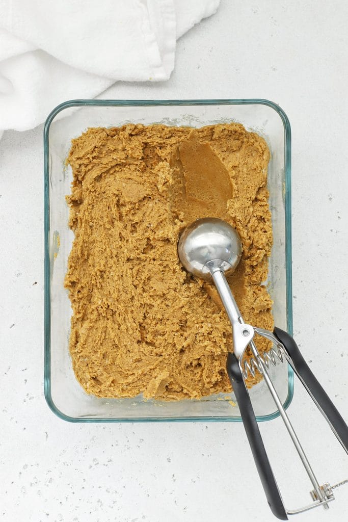 Scooping gluten-free ginger cookie dough into balls