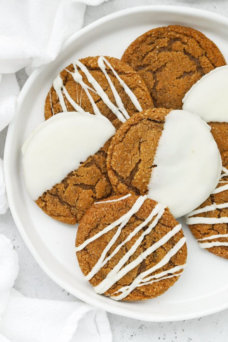 Overhead view of soft, chewy gluten-free ginger cookies drizzled and dipped in white chocolate