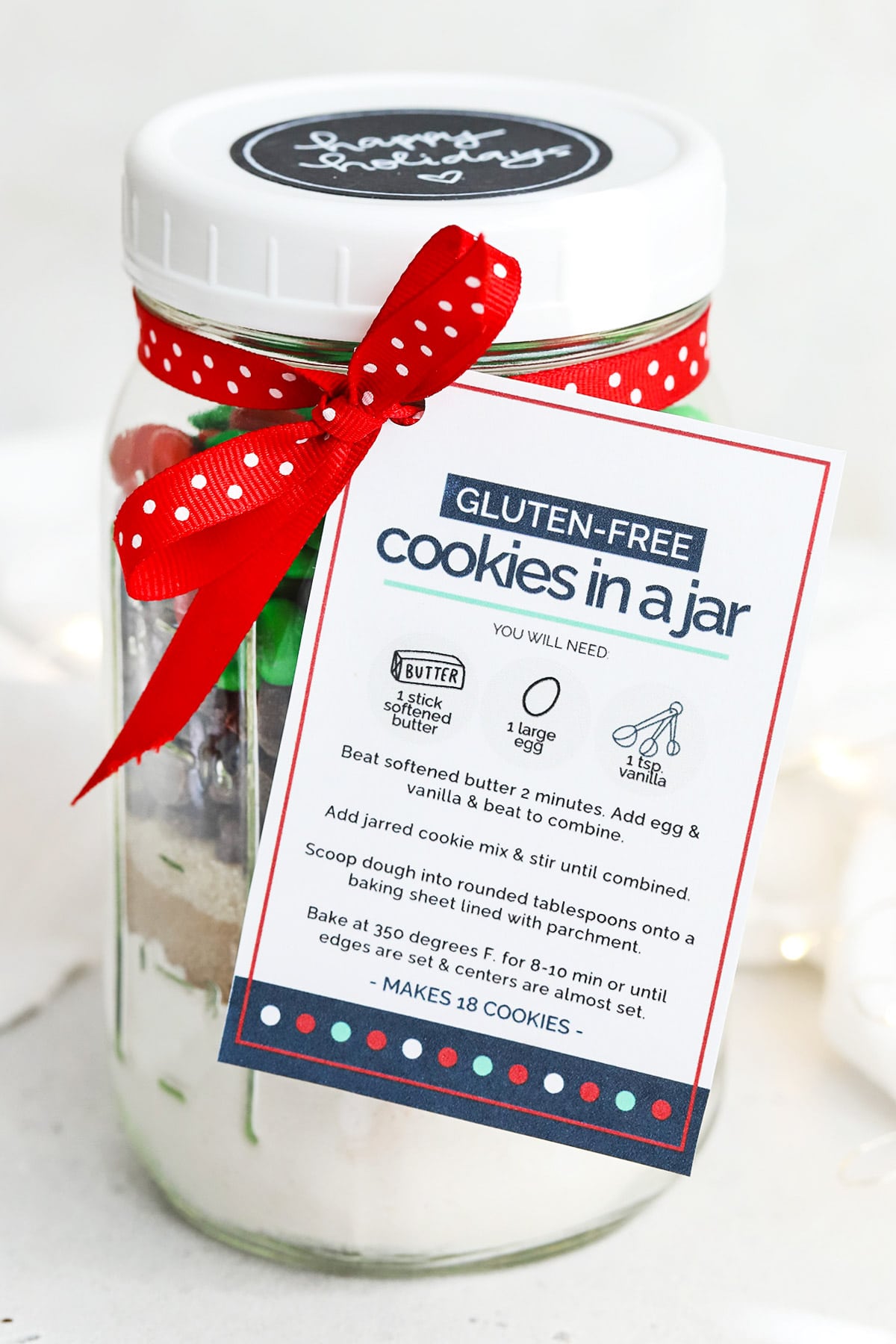 Front view of gluten-free holiday cookies in a jar with free printable gift tag