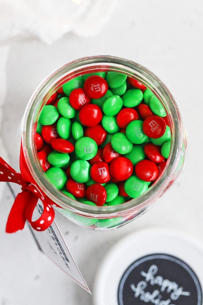 Overhead view of red and green m&ms in a gluten-free cookies in a jar mix