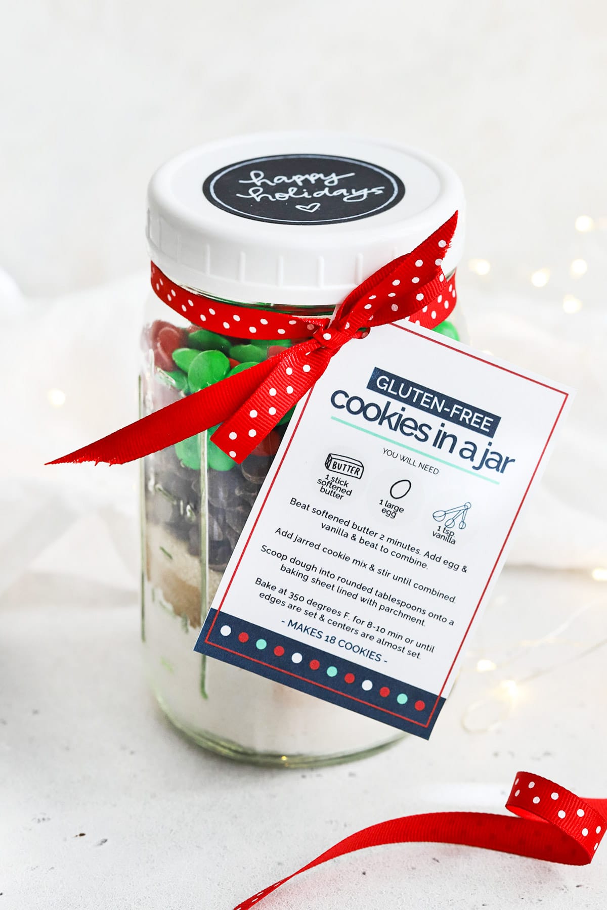 Front view of gluten-free holiday cookies in a jar with free printable gift tag