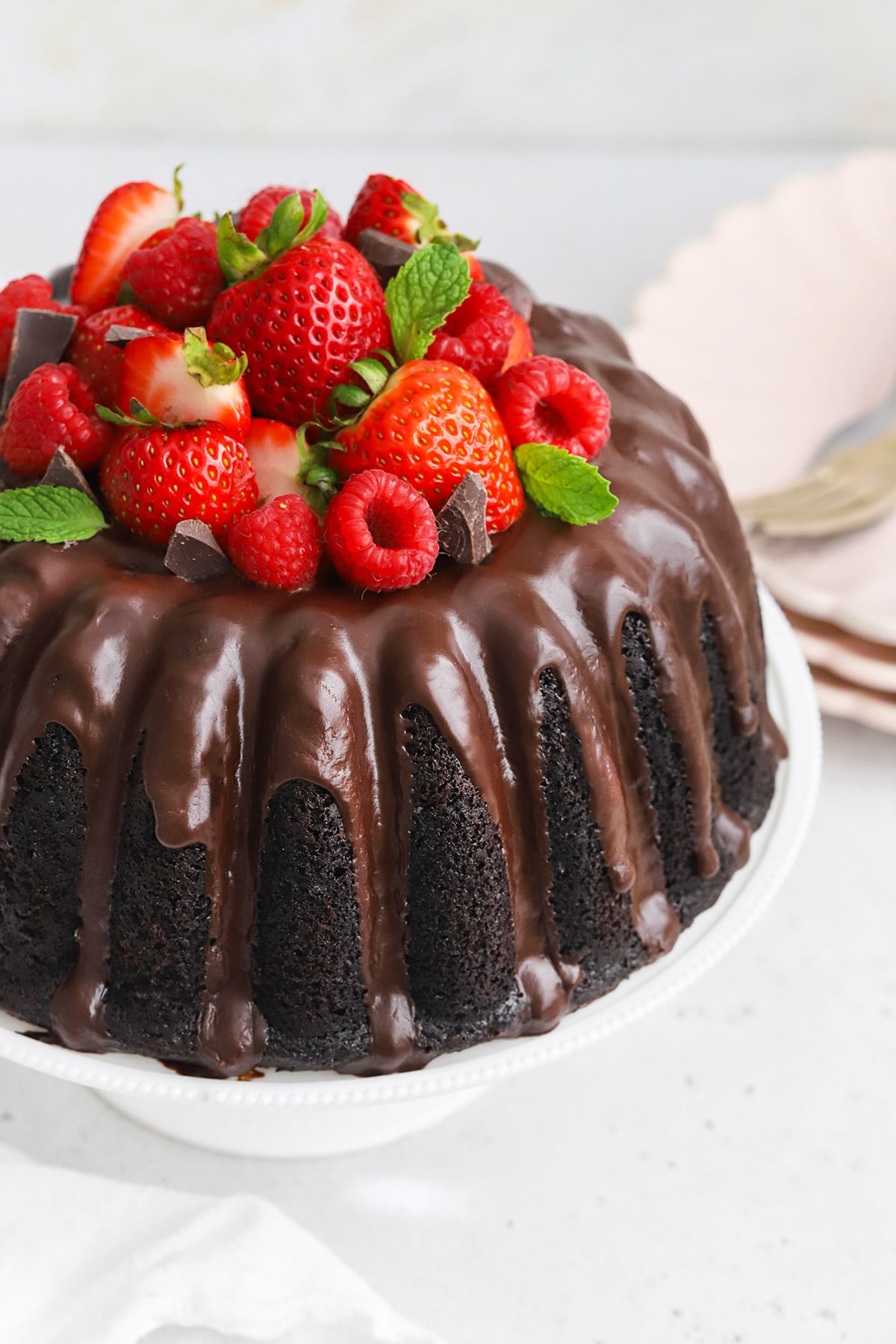 Front view of gluten-free bundt cake with chocolate glaze