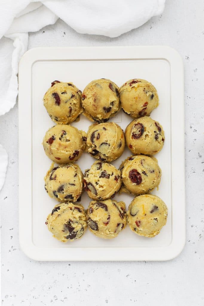 Scooped balls of gluten-free orange cranberry chocolate chip cookie dough