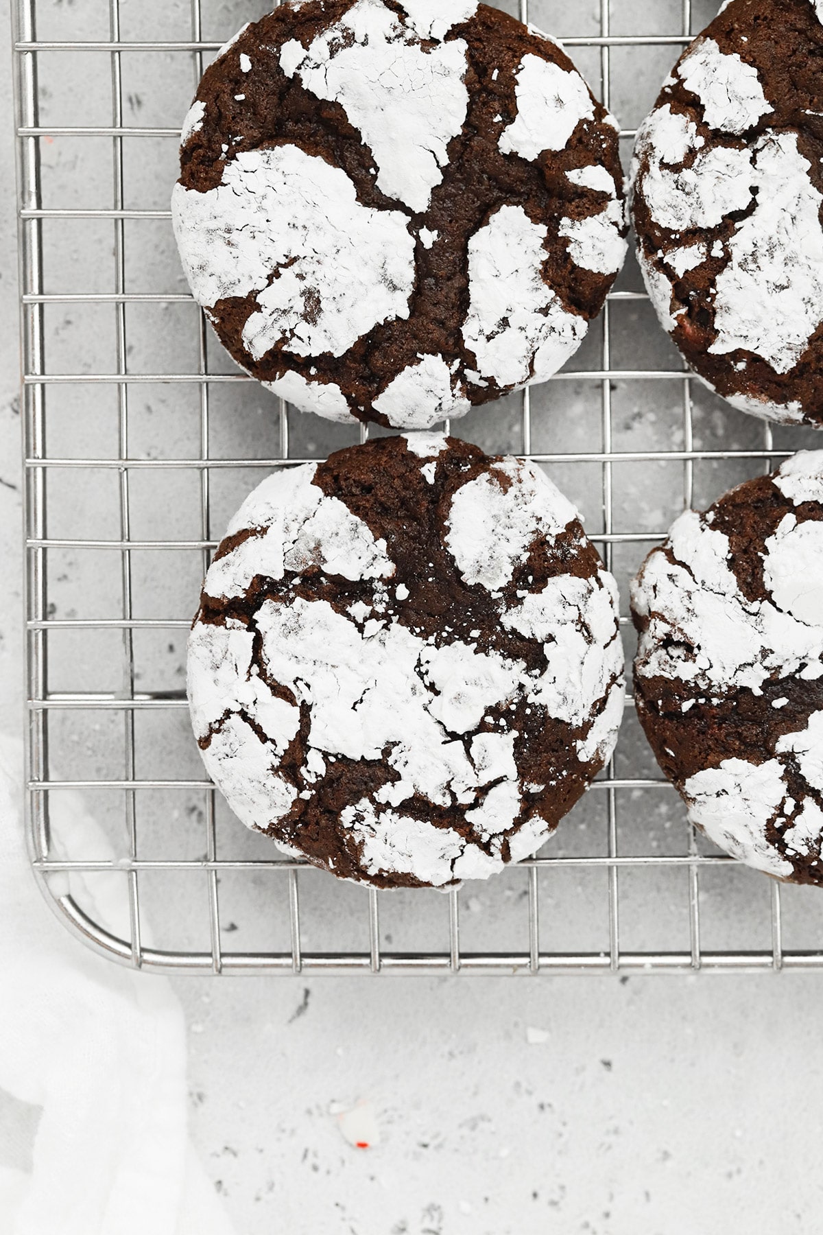 Overhead view of gluten-free peppermint chocolate crinkle cookies on a cooling rack