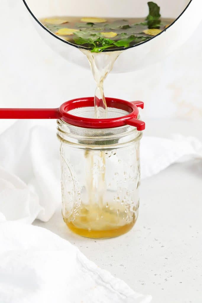 Straining Ginger Mint Simple Syrup for Citrus Mocktails