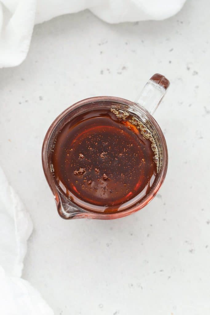 Overhead view of a small glass pitcher of pure maple syrup