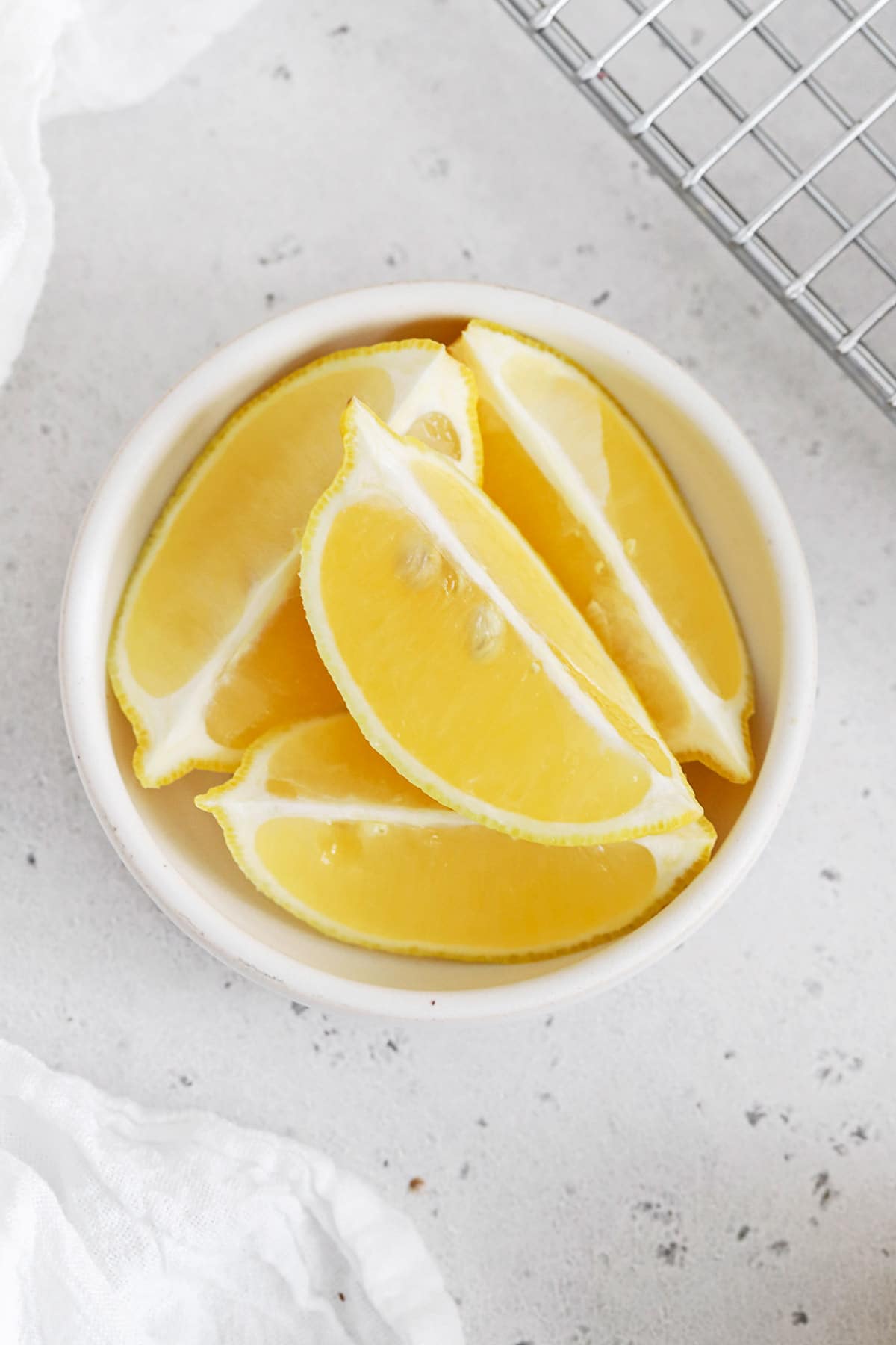 Overhead view of a bowl of lemon wedges