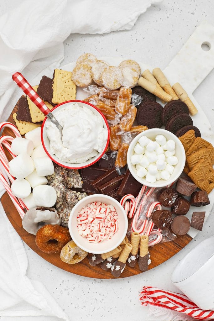 Overhead view of a gluten-free hot chocolate charcuterie board with toppings and mix-ins