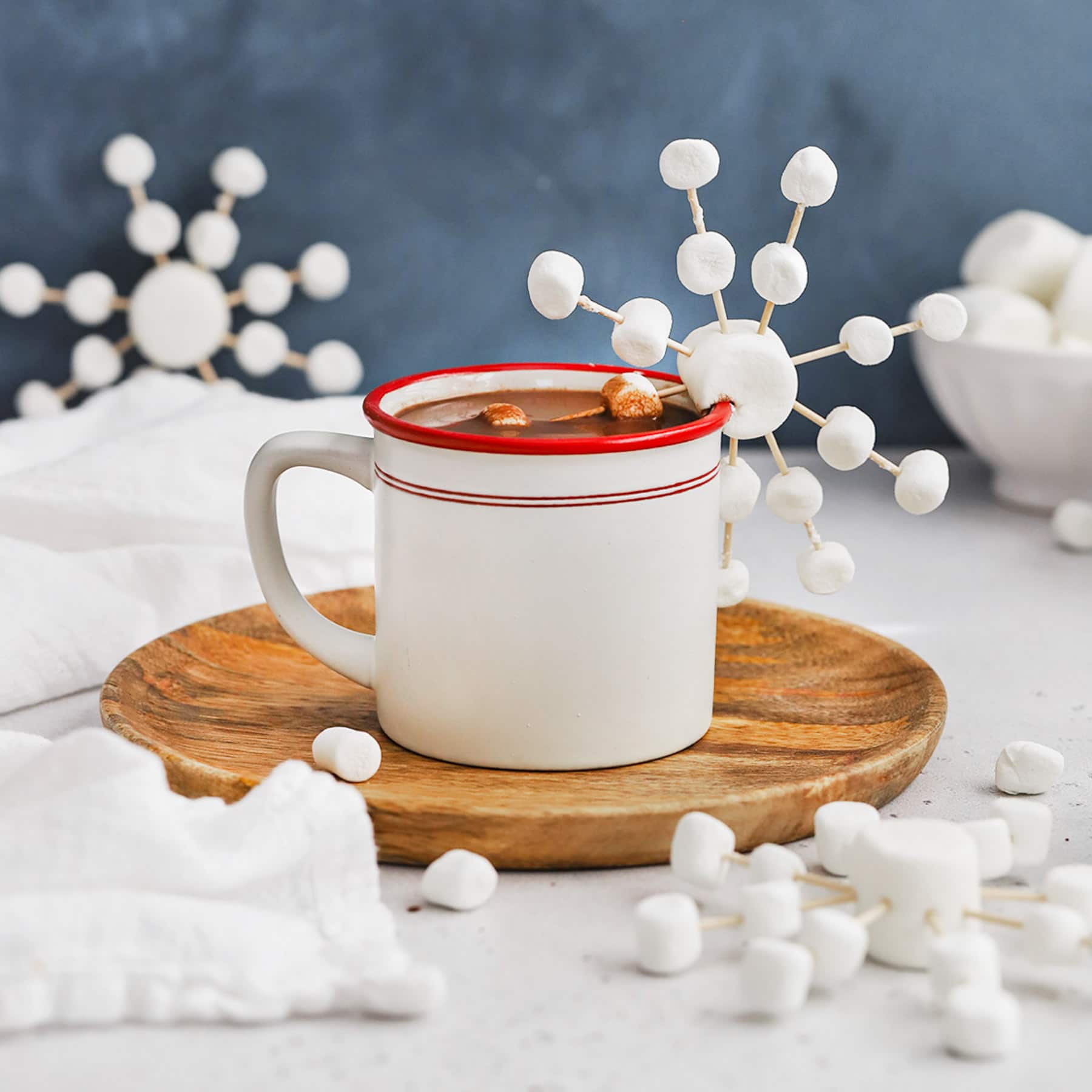 Front view of marshmallow snowflakes made out of marshmallows and toothpicks on a mug of peppermint hot chocolate from Sweets & Thank You