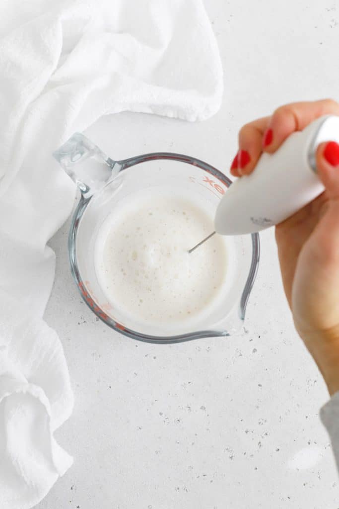 Using a frother to add foam to a vanilla steamer