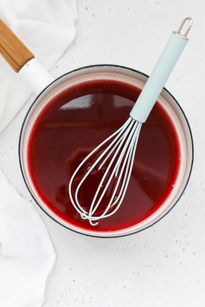 Overhead view of a saucepan full of homemade grenadine syrup