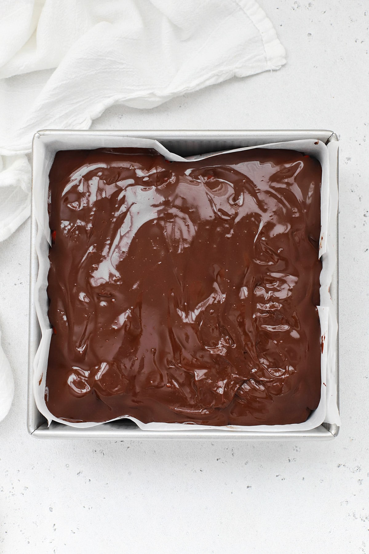 Overhead view of gluten-free chocolate covered strawberry brownies topped with ganache