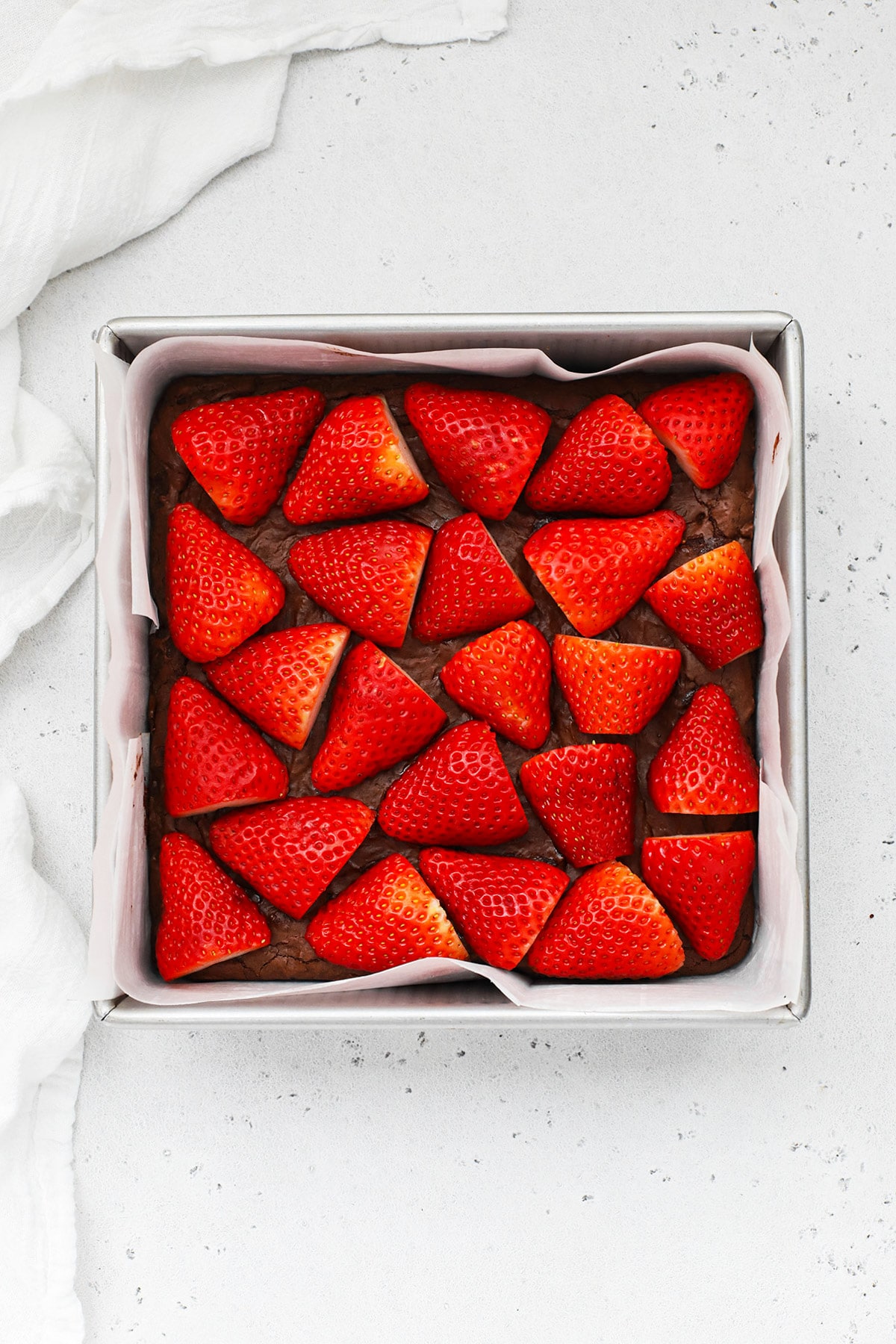 Overhead view of gluten-free brownies topped with strawberries