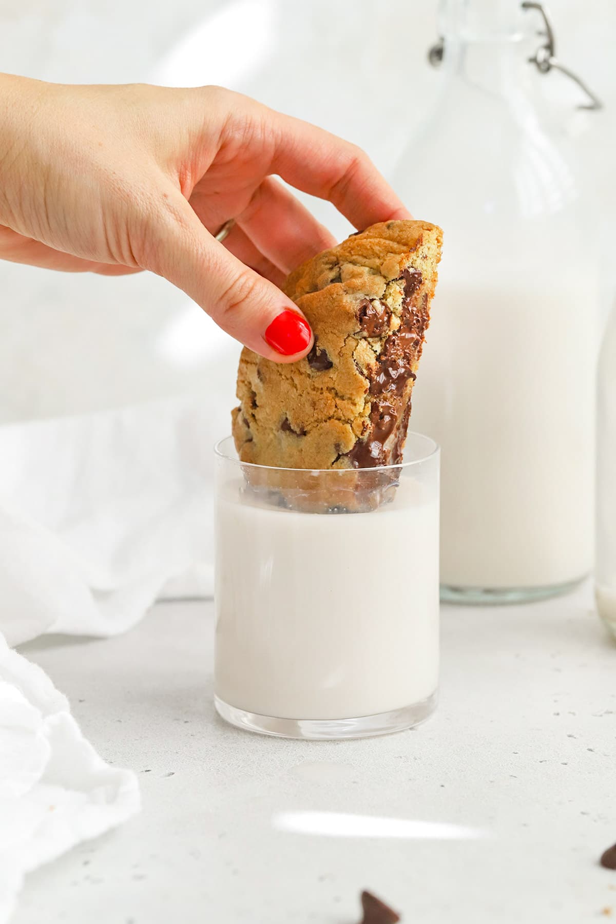Dunking a gluten-free Levain chocolate chip cookie in milk