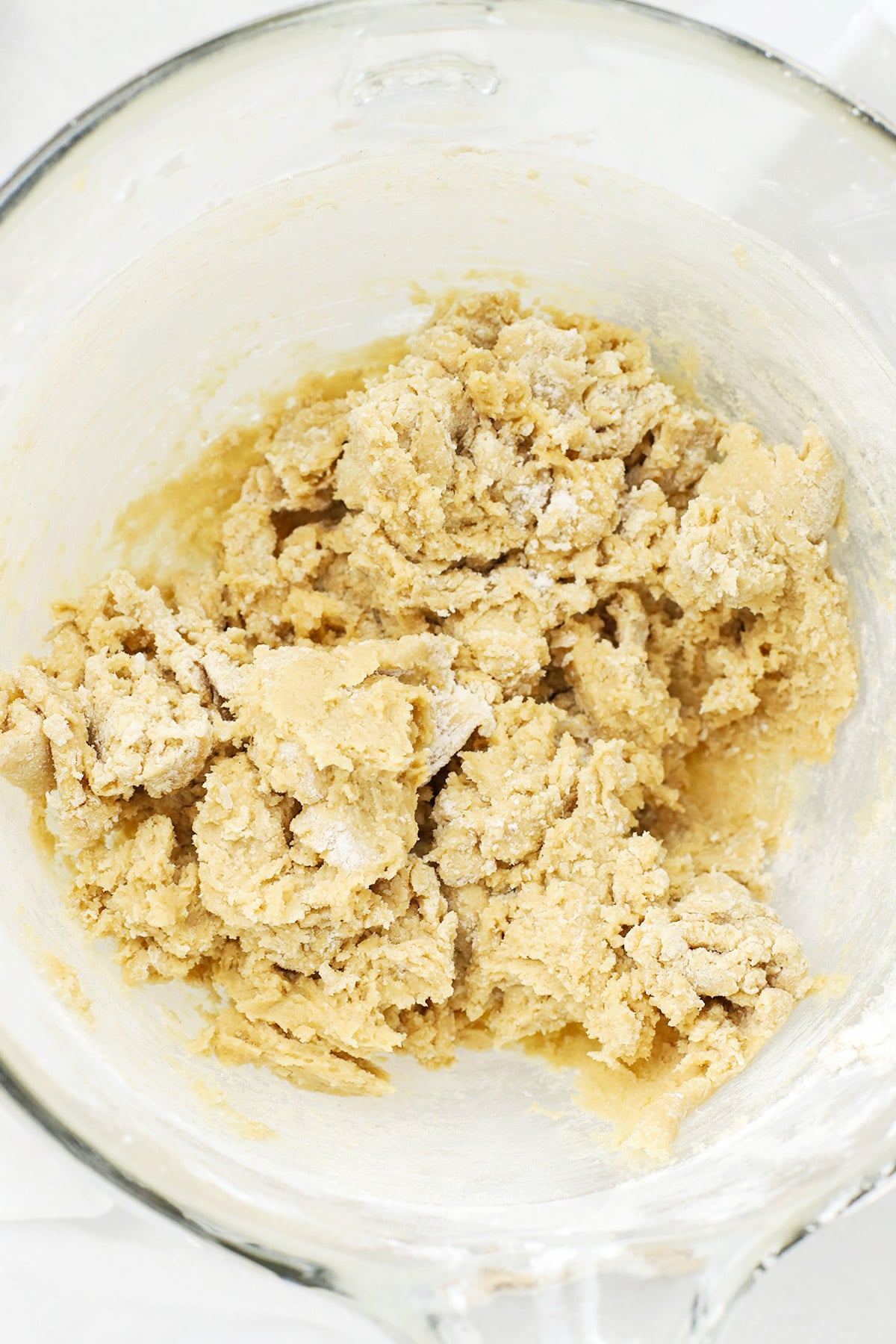 Mixing dry ingredients into thick gluten-free chocolate chip cookie dough