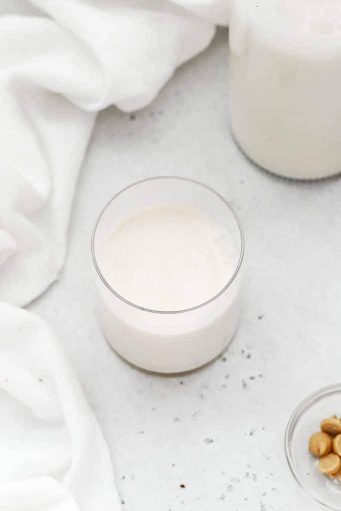 almond milk in a glass, ready to dip cookies