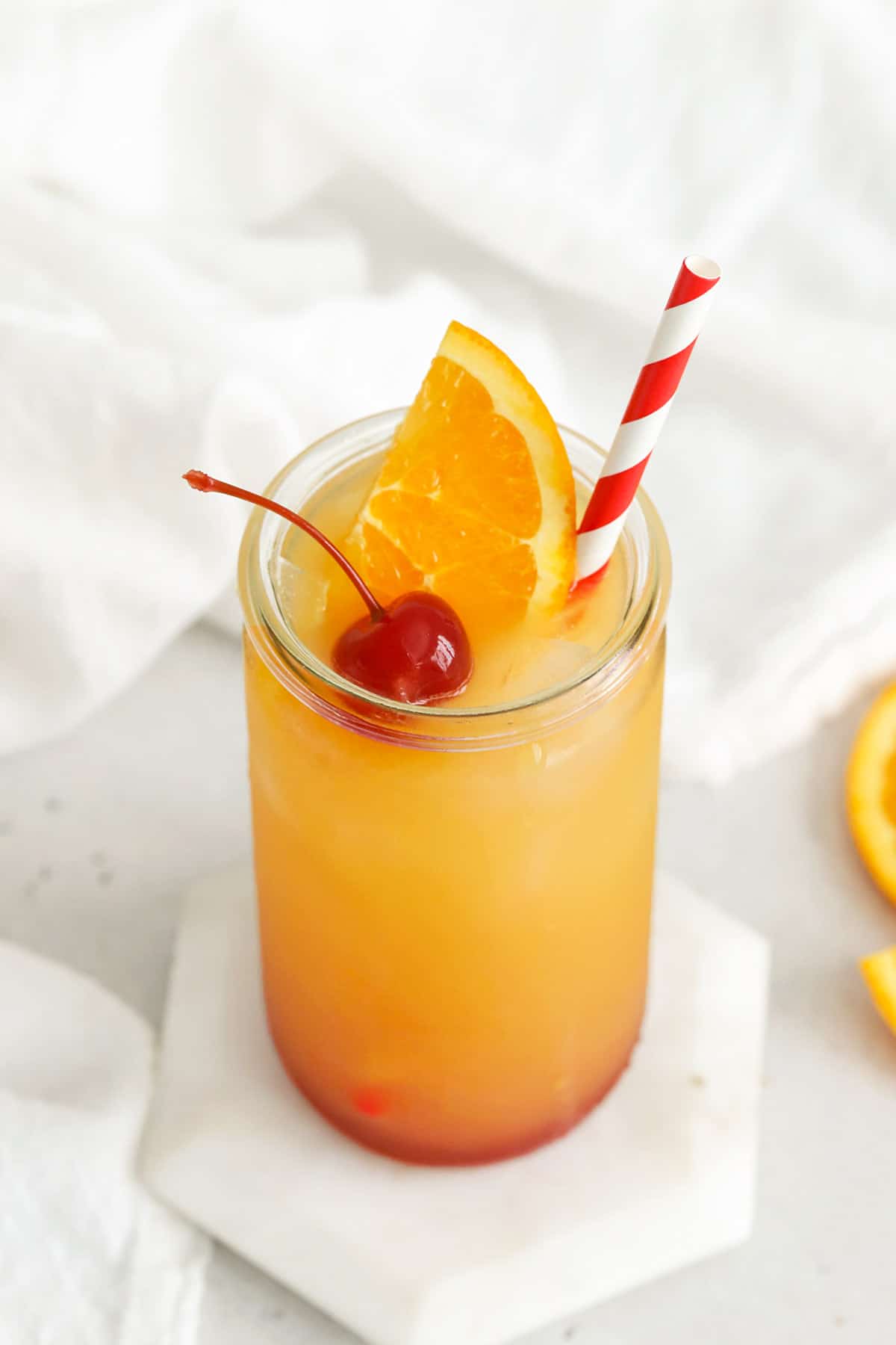 Front view of virgin sunrise mocktail from Sweets & Thank You