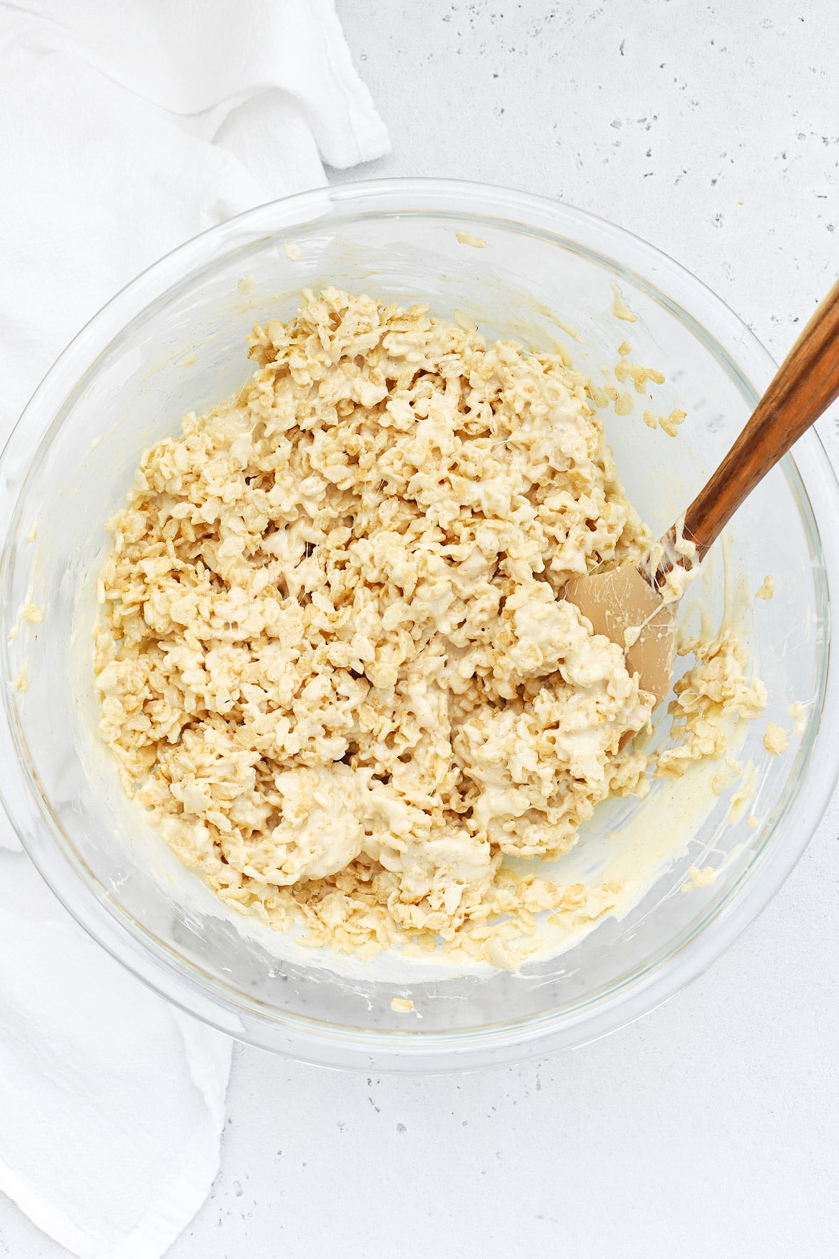 Stirring the marshmallow mixture into gluten-free brown butter rice krispies treats