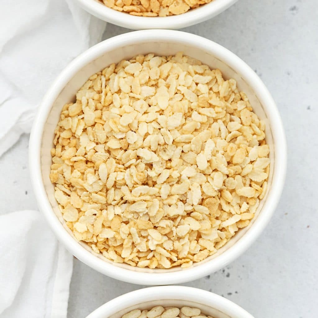 Overhead view of four bowls of gluten-free crisp rice cereals
