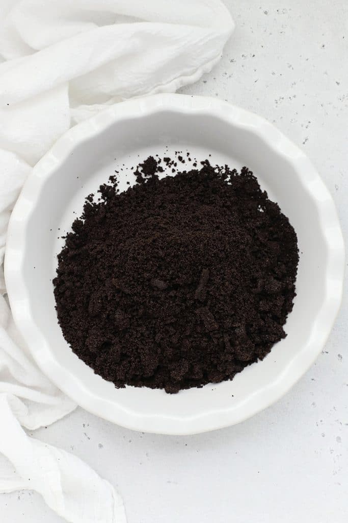 Patting down oreo crumbs for a gluten-free oreo crust