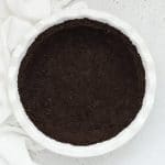 Overhead view of gluten-free oreo crust in a white pie pan