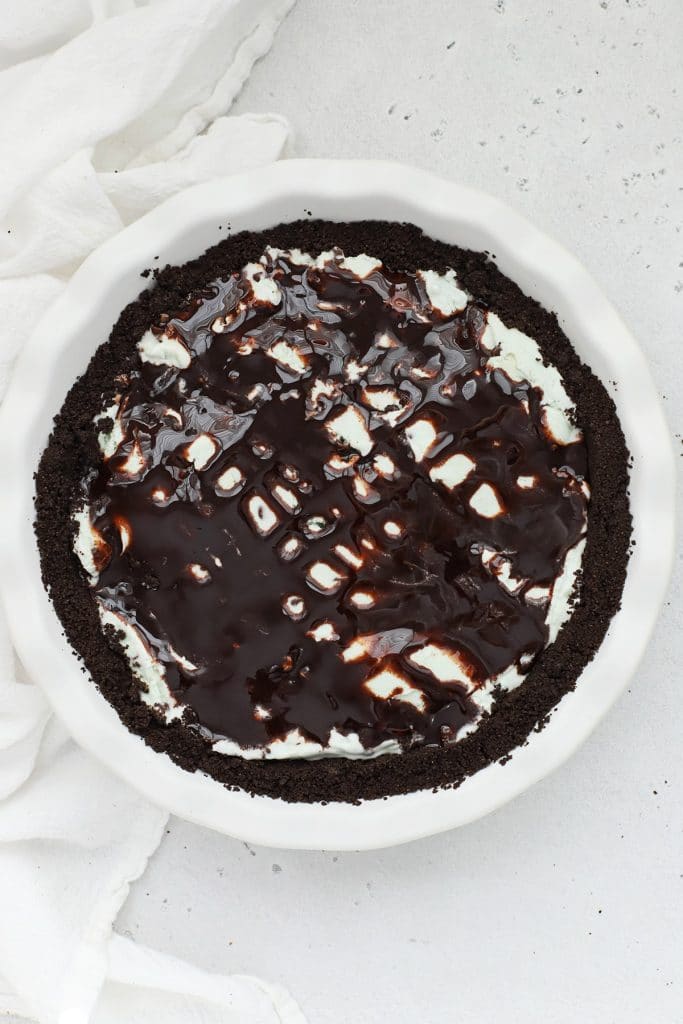 Overhead view of gluten-free grasshopper ice cream pie drizzled with chocolate sauce