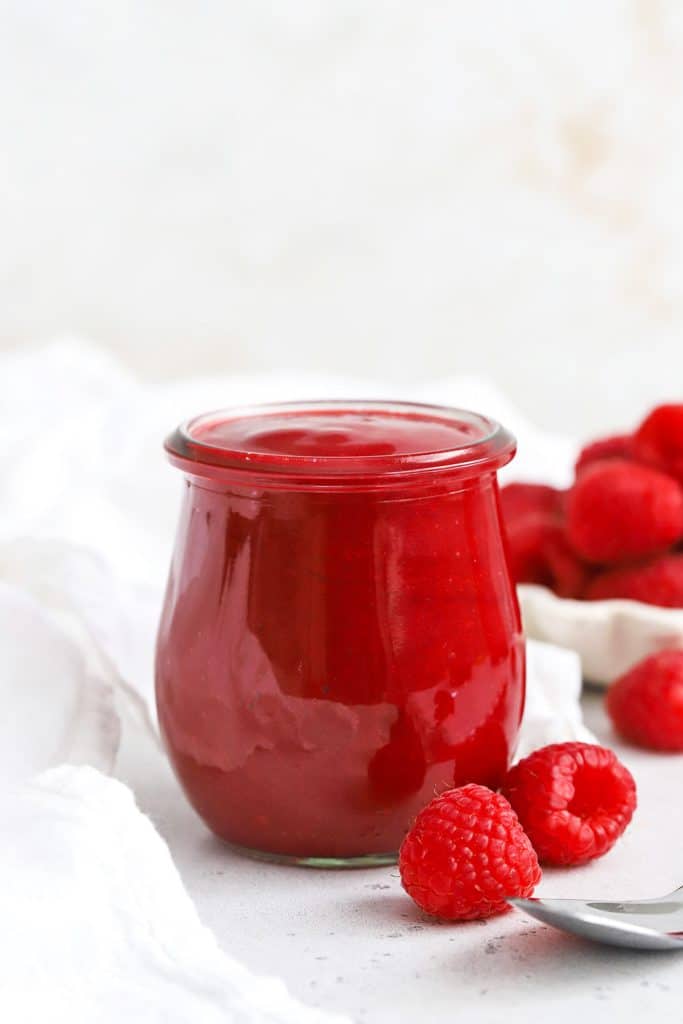 Front view of a jar of fresh raspberry sauce