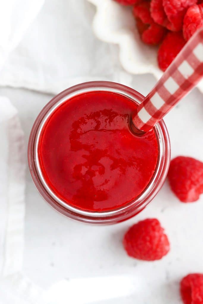 Overhead view of a jar of fresh raspberry sauce