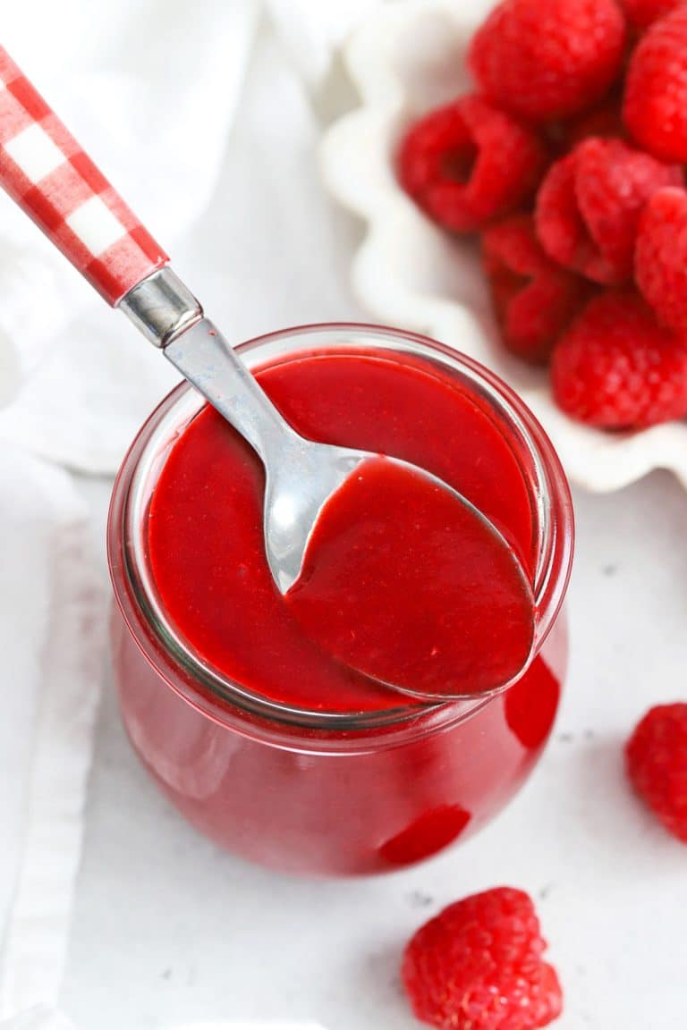 Front view of fresh raspberry coulis in a jar