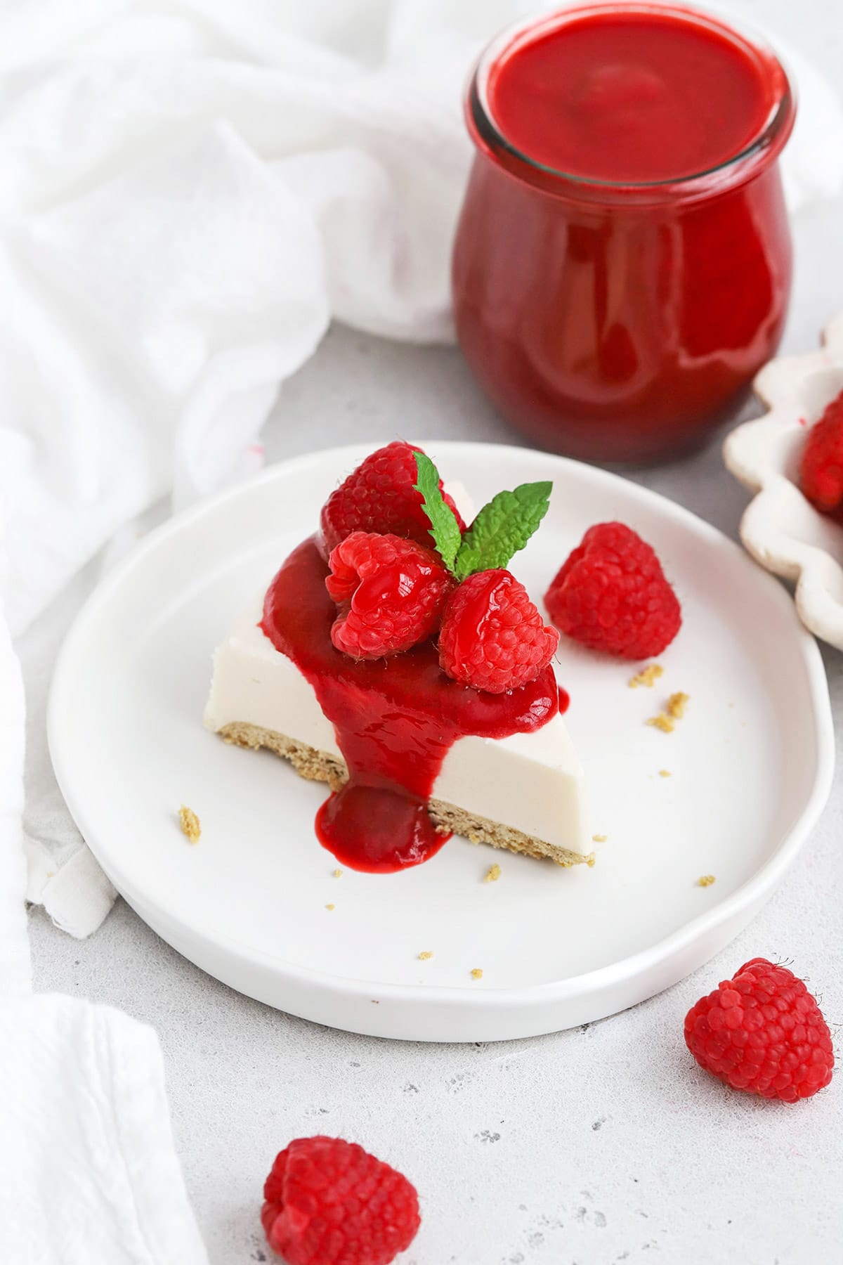Front view of cheesecake with raspberry sauce