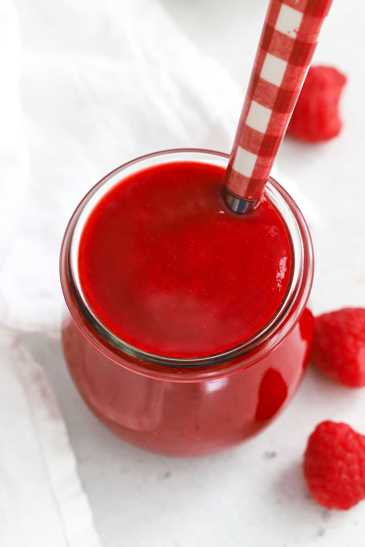 Front view of fresh raspberry sauce in a jar