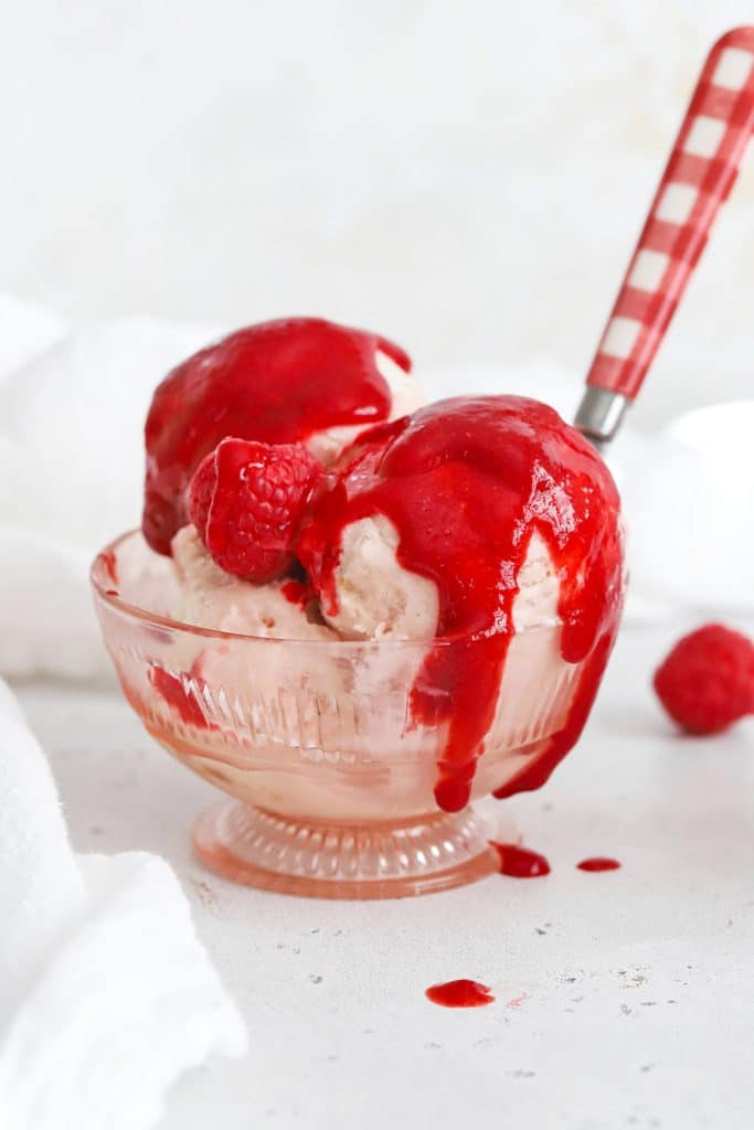 Front view of strawberry ice cream covered with raspberry sauce