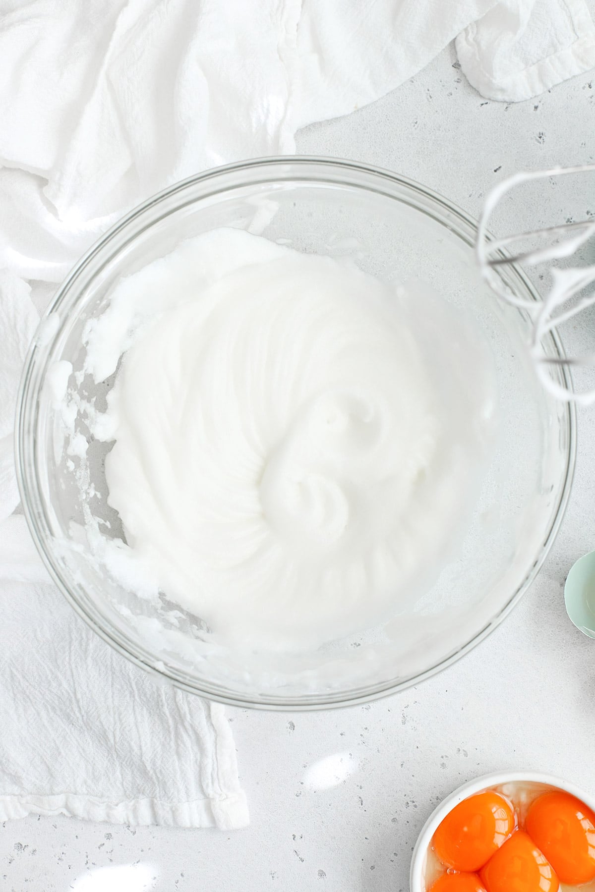 Overhead view of egg whites whipped to soft peaks