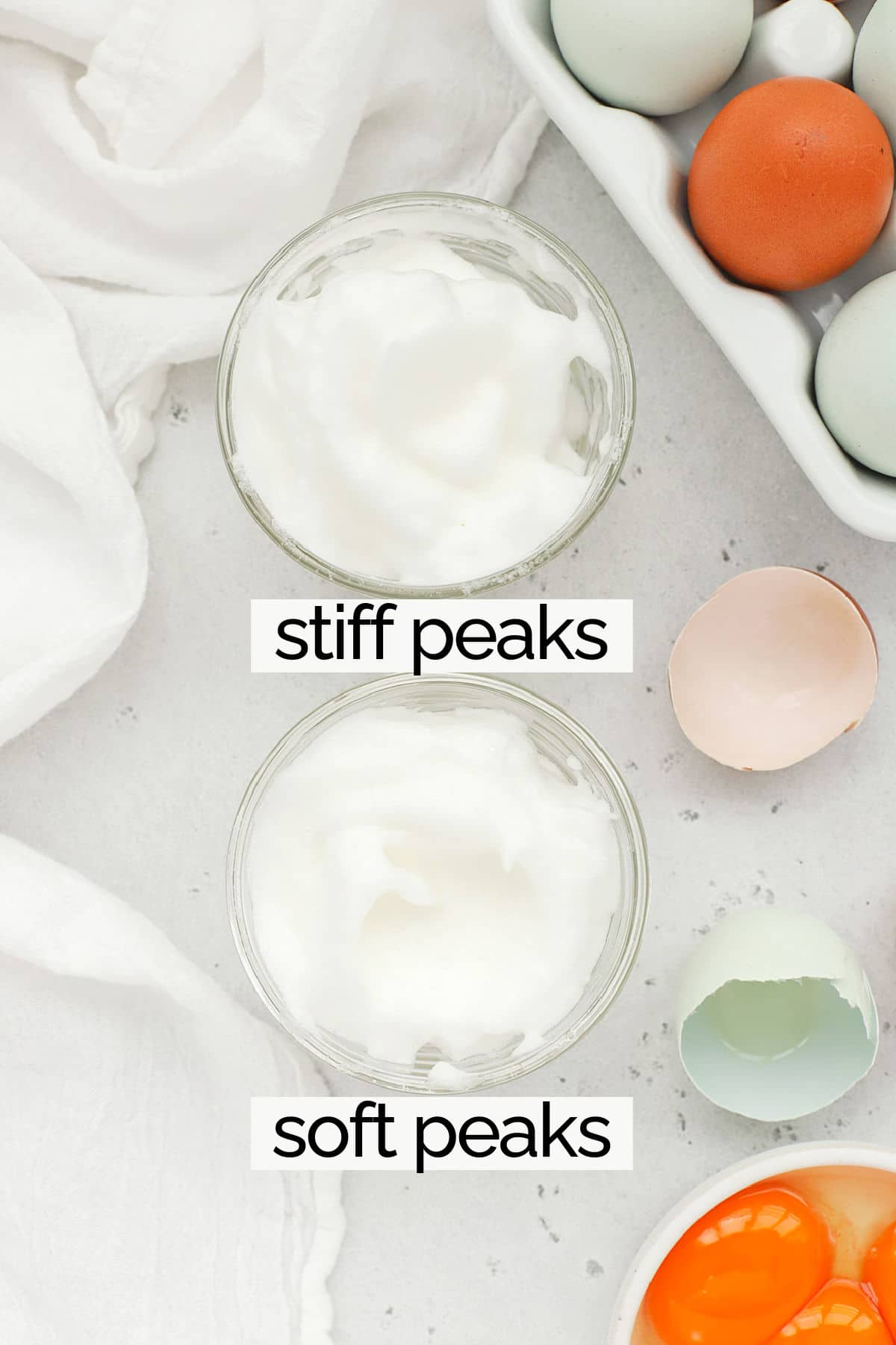 Overhead view of a bowl of egg whites whipped to soft peaks and a bowl of egg whites whipped to stiff peaks