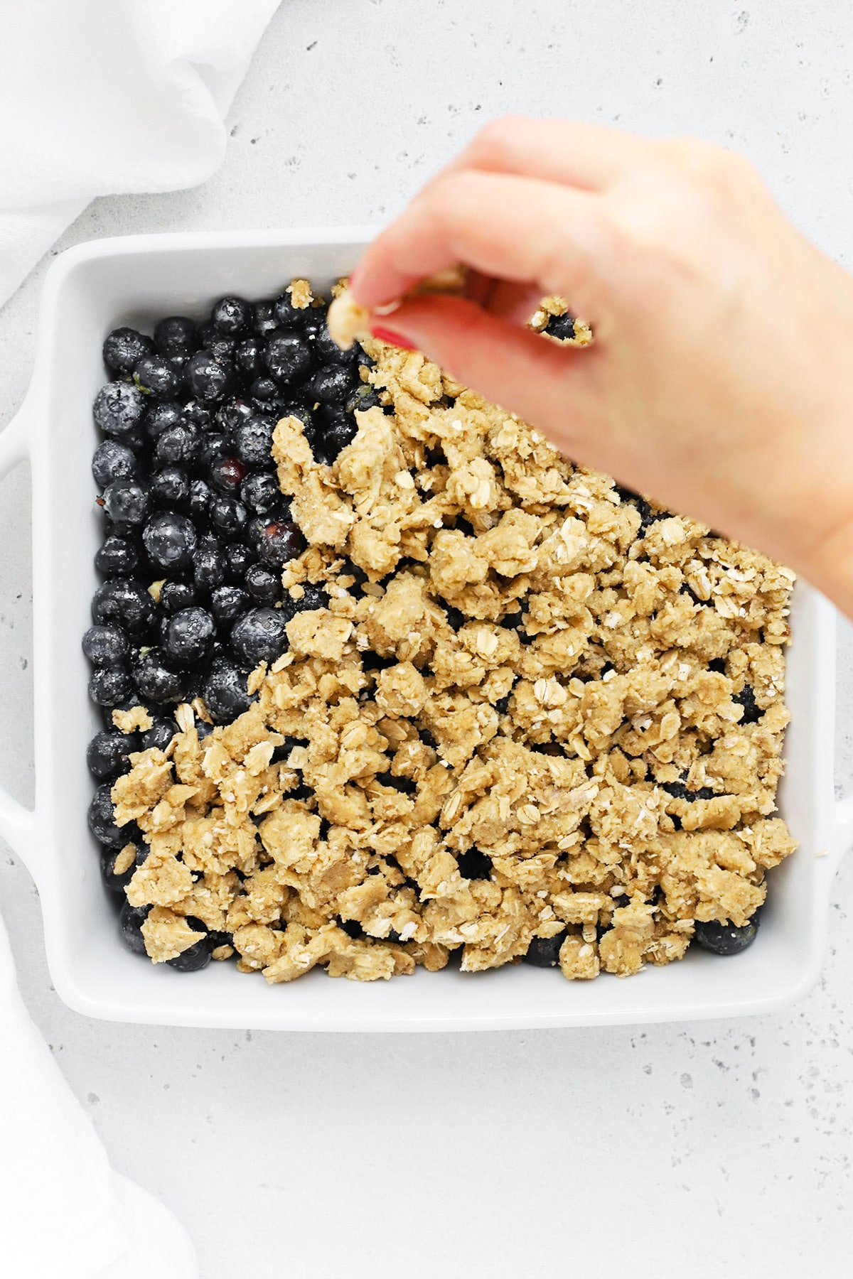 Adding crumble topping to gluten-free blueberry crisp