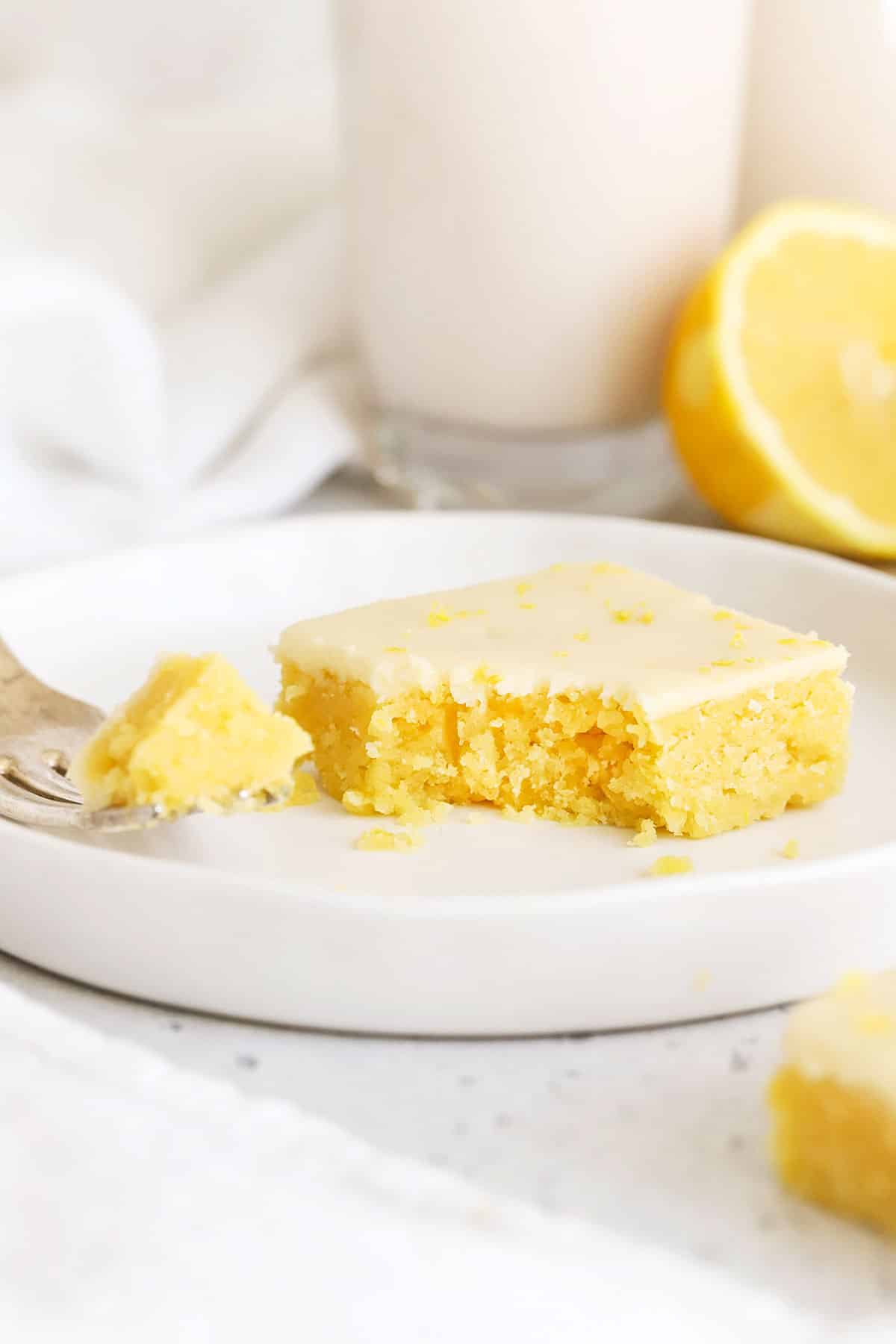 A fork taking a bite out of a gluten-free lemon brownie